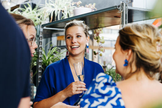 Gasten met champagne op het Werk aan de Muur tafelboek evenemenrt