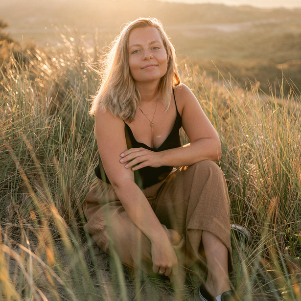 Photo of artists sitting in sand dunes