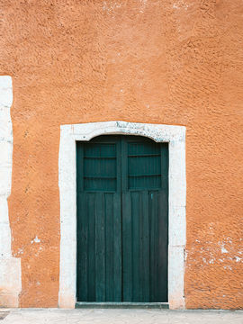 A close up of a green door from a house in Mexico