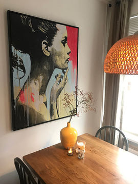 Portrait art above the dining table