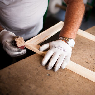 Man sanding an art frame