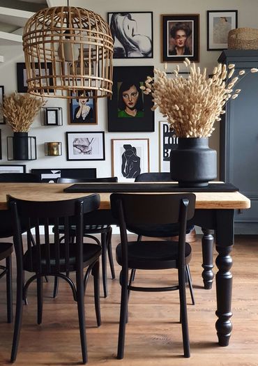 Brown and black dining interior with a matching art wall collage